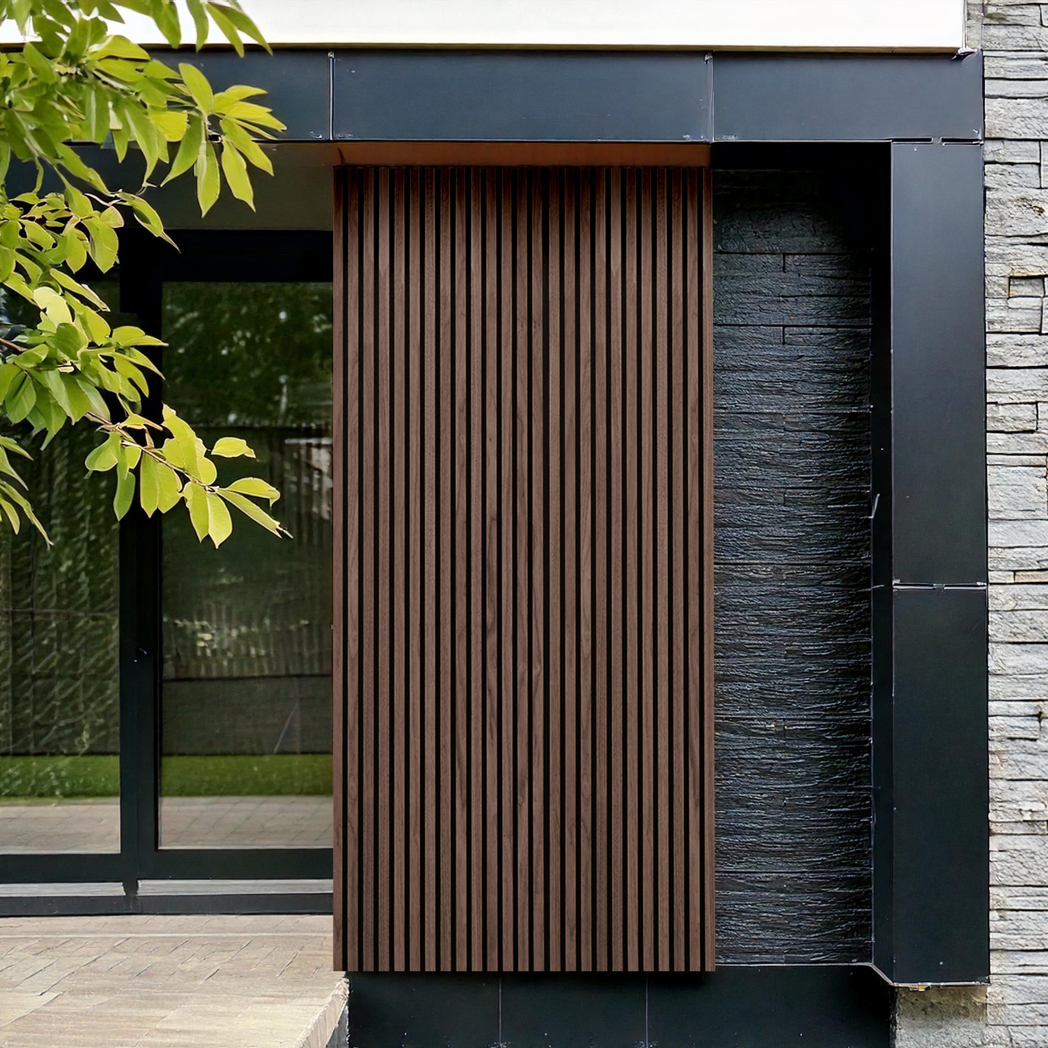 Modern facade featuring Landmark Decor’s Rosewood Exterior WPC Panel, black metal framing, stone wall panel, and glass door—a stylish mix of exterior finishes. Tree branches in the foreground add a natural accent.
