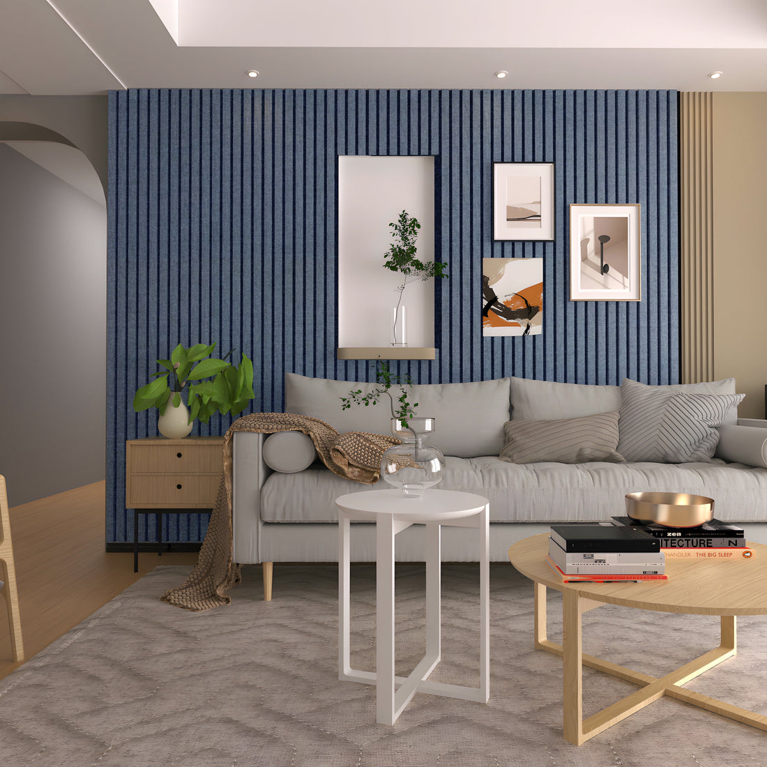 Modern living room featuring a gray sofa, Landmark Decor’s Navy Blue WPC Fluted Slat Wall Panel accent wall, stylish wall art, two round coffee tables, a beige rug, and decorative plants.